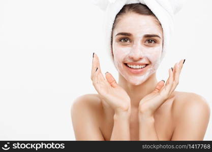 Beauty Skin Care Concept - Beautiful Caucasian Woman Face Portrait applying cream mask on her facial skin white background. Beauty Skin Care Concept - Beautiful Caucasian Woman Face Portrait applying cream mask on her facial skin white background.