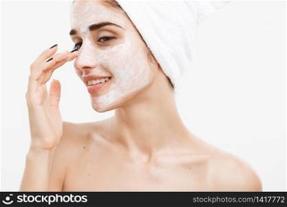 Beauty Skin Care Concept - Beautiful Caucasian Woman Face Portrait applying cream mask on her facial skin white background. Beauty Skin Care Concept - Beautiful Caucasian Woman Face Portrait applying cream mask on her facial skin white background.