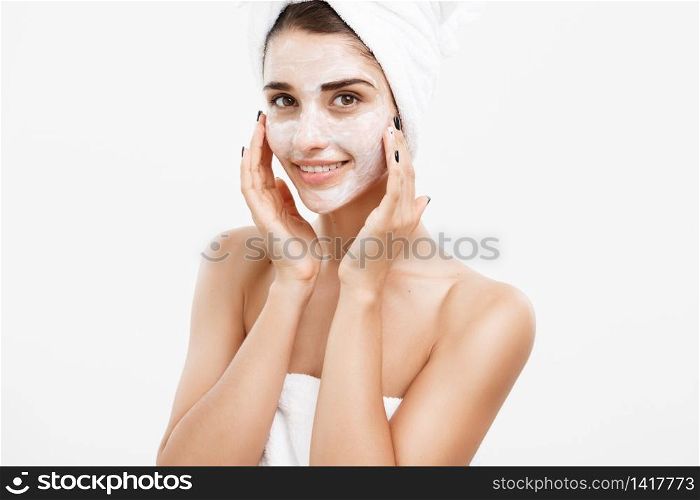 Beauty Skin Care Concept - Beautiful Caucasian Woman Face Portrait applying cream mask on her facial skin white background. Beauty Skin Care Concept - Beautiful Caucasian Woman Face Portrait applying cream mask on her facial skin white background.