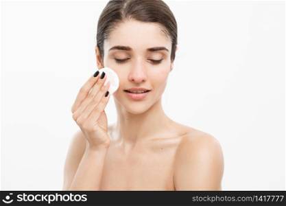 Beauty Skin Care Concept - Beautiful woman cleaning her face with cotton swab - over white background and smiling. Beauty Skin Care Concept - Beautiful woman cleaning her face with cotton swab - over white background and smiling.
