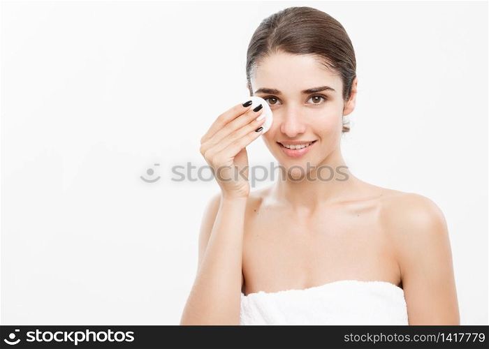 Beauty Skin Care Concept - Beautiful woman cleaning her face with cotton swab - over white background and smiling. Beauty Skin Care Concept - Beautiful woman cleaning her face with cotton swab - over white background and smiling.
