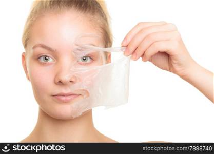 Beauty skin care cosmetics and health concept. Closeup young woman face, girl removing facial peel off mask isolated on white. Peeling