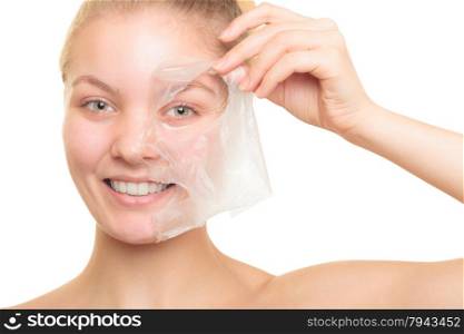 Beauty skin care cosmetics and health concept. Closeup young woman face, girl removing facial peel off mask isolated on white. Peeling