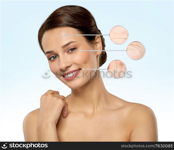 beauty, skincare and people concept - beautiful young woman with face wrinkles in zoomed pointers over blue background. young woman with face wrinkles in zoomed pointers