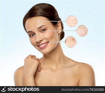 beauty, skincare and people concept - beautiful young woman with face wrinkles in zoomed pointers over blue background. young woman with face wrinkles in zoomed pointers