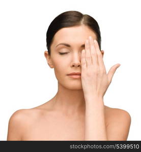 beauty, spa and health concept - calm young woman covering half of face with hand