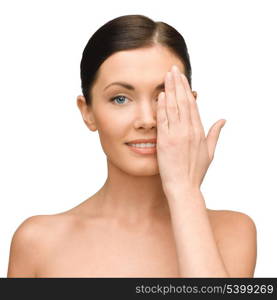 beauty, spa and health concept - smiling young woman covering half of face with hand