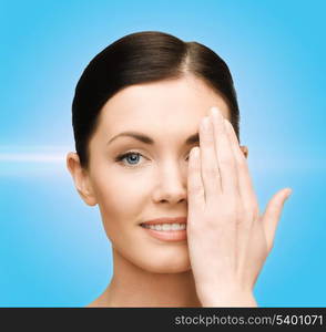 beauty, spa and health concept - smiling young woman covering half of face with hand