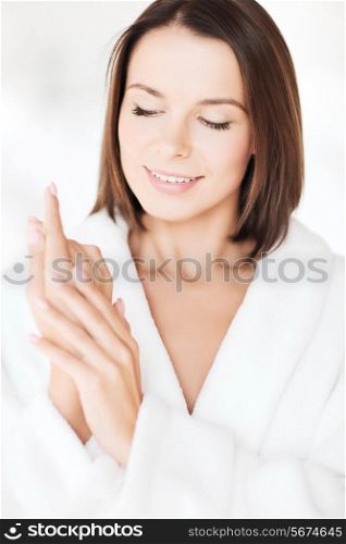 beauty, spa and people concept - beautiful woman in bathrobe