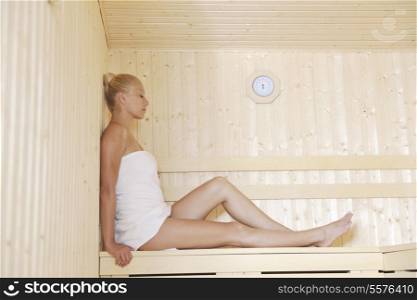 beauty spa and wellnes body treatment with young woman at wooden sauna