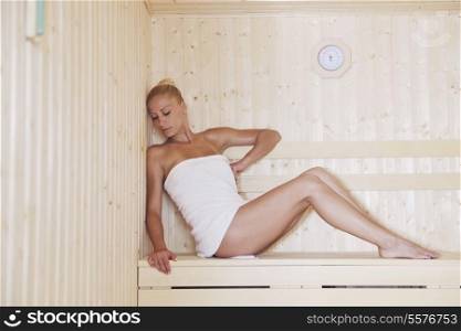 beauty spa and wellnes body treatment with young woman at wooden sauna