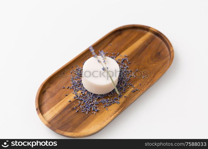 beauty, spa and wellness concept - close up of crafted lavender soap on wooden tray. close up of crafted lavender soap on wooden tray