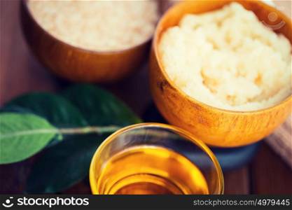 beauty, spa, body care, natural cosmetics and wellness concept - close up of body scrub in wooden bowl. close up of body scrub in wooden bowl