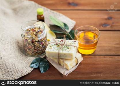 beauty, spa, body care, natural cosmetics and wellness concept - close up of handmade soap bars on wooden table