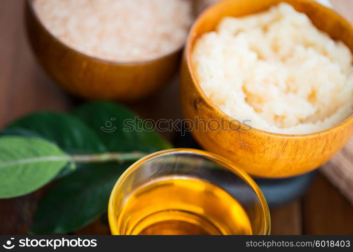beauty, spa, body care, natural cosmetics and wellness concept - close up of body scrub in wooden bowl