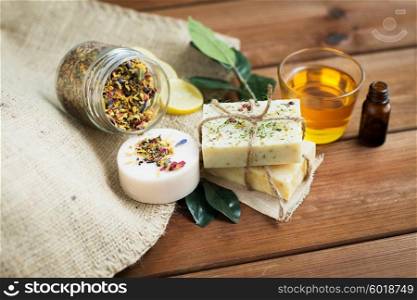 beauty, spa, body care, natural cosmetics and wellness concept - close up of handmade soap bars on wooden table