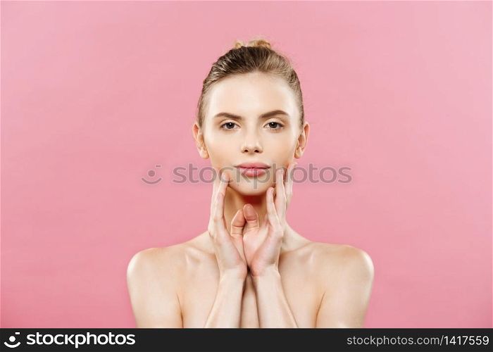 Beauty Spa Concept - Caucasian Woman with perfect face skin Portrait. Beautiful Brunette Spa Girl showing empty copy space. Isolated on pink studio background. Proposing a product. Beauty Spa Concept - Caucasian Woman with perfect face skin Portrait. Beautiful Brunette Spa Girl showing empty copy space. Isolated on pink studio background. Proposing a product.
