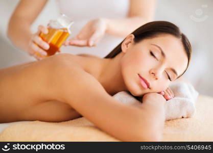 beauty, spa, resort and relaxation concept - beautiful woman in spa salon