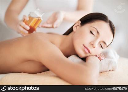 beauty, spa, resort and relaxation concept - beautiful woman in spa salon