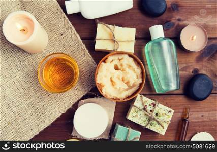 beauty, spa, therapy, natural cosmetics and wellness concept - close up of body care cosmetic products on wood. close up of body care cosmetic products on wood