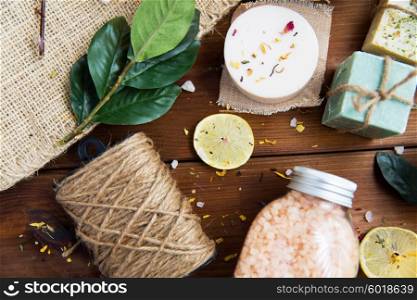 beauty, spa, therapy, natural cosmetics and wellness concept - close up of body care cosmetic products on wood