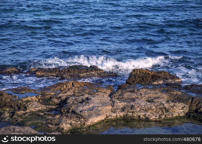 Beauty sunny day view of sea waves with rocks