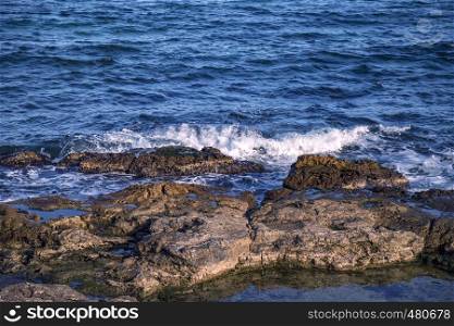 Beauty sunny day view of sea waves with rocks
