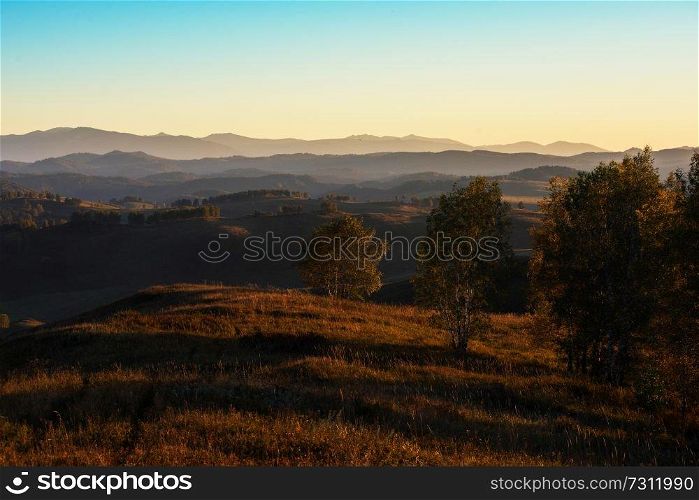 Beauty sunset in the mountains in Altay, panoramic picture. Autumn photo.. Beauty sunset in the mountains