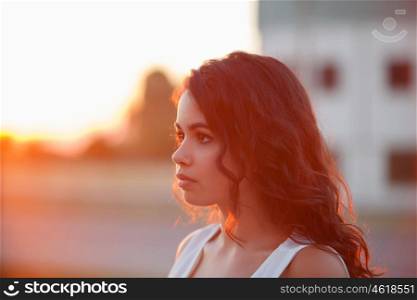 Beauty Sunshine Girl Portrait. Sunny Summer Day under the Hot Sun. Happy Woman Smiling and looking at camera.