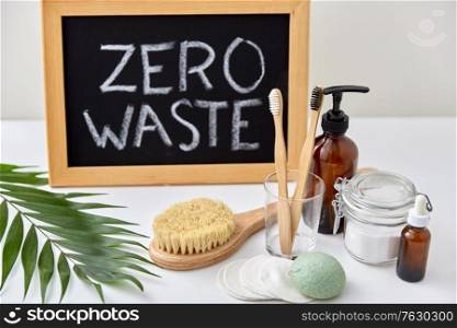 beauty, sustainability and eco living concept - natural cosmetics, bodycare, hygienic eco products and chalkboard with zero waste words or lettering on white background. natural cosmetics, bodycare and hygienic products