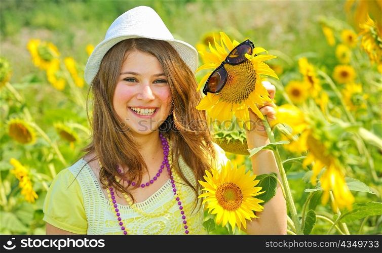 Beauty teen girl and sunflowers