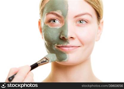 Beauty treatment concept. Cosmetician applying clay facial mask at woman face. Body care healthy lifestyle.