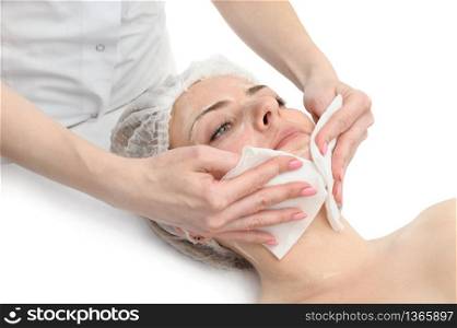 Beauty treatment procedure, wiping the facial mask from face