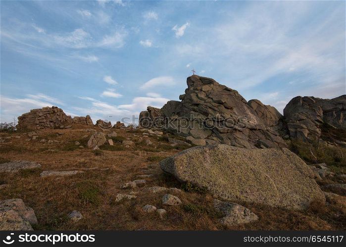 Beauty view in mountains of Altai. Christian cross on top of Sinyukha mountain, Kolyvan ridge - a mountain ridge in the north-west of the Altai Mountains, in the Altai Territory of Russia