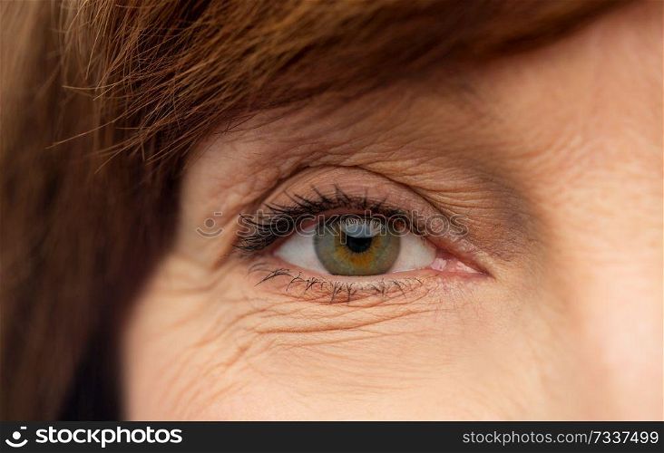 beauty, vision and old people concept - eye of senior woman. eye of senior woman