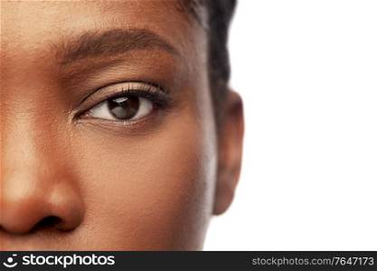 beauty, vision and people concept - close up of face of beautiful young african american woman over white background. close up of face of young african american woman