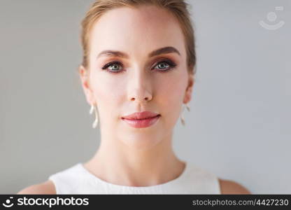 beauty, wedding and people concept - face of beautiful woman or bride in white dress