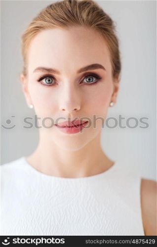 beauty, wedding and people concept - face of beautiful woman or bride in white dress