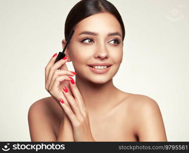 Beauty woman applying black mascara on eyelashes with makeup brush. Eyelash extensions. makeup, cosmetics. beauty, skincare