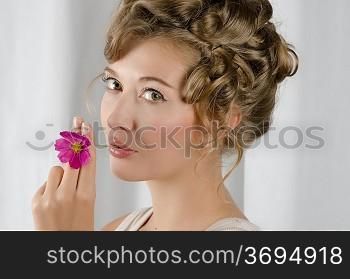 beauty woman closeup portrait with flower over grey background