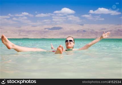 Beauty Woman Lying On Water. Dead Sea. Israel