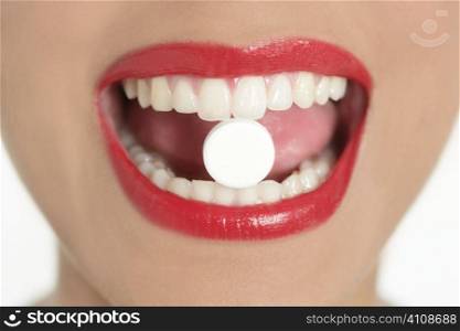 Beauty woman mouth with red lips and medicine pill