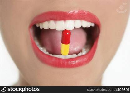 Beauty woman mouth with red lips and medicine pill