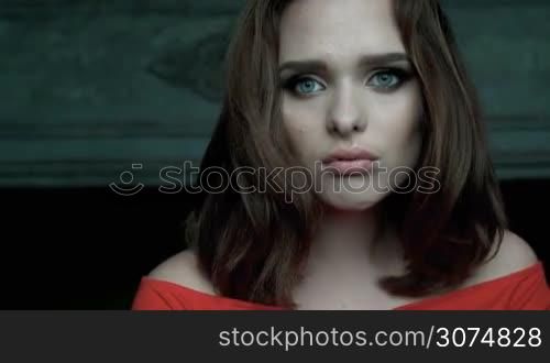 Beauty woman portrait with blue eyes and red dress