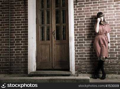 Beauty Woman Standing Against Old Brick Building