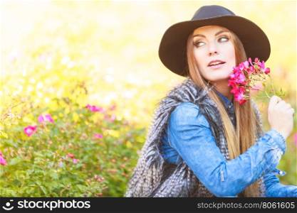 Beauty woman with flowers. Freedom and leisure. Gorgeous adorable woman holding pink flowers. Romantic portrait of beautiful young lady.