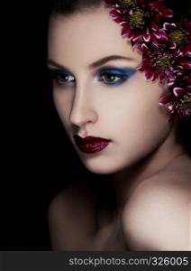 Beauty woman with flowers on black background.Fashion portrait.Headshot. Creative portrsit.