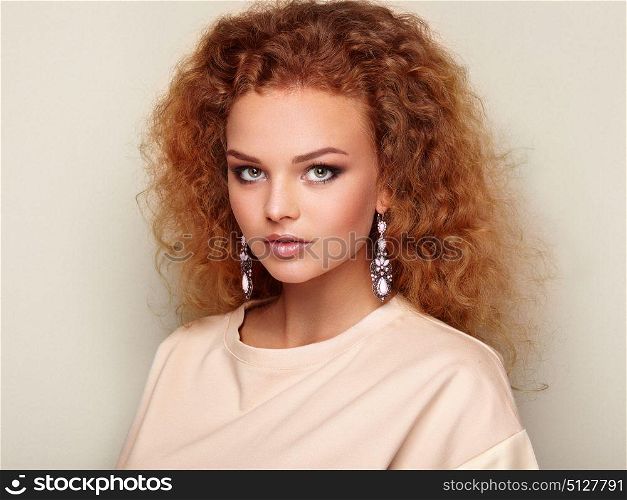 Beauty woman with long and shiny curly hair. Perfect make-up. Beauty style model with jewelry. Fashion photo