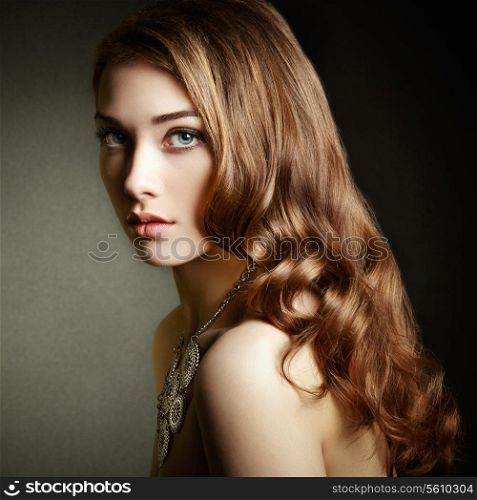 Beauty woman with long curly hair. Beautiful girl with elegant hairstyle. Fashion photo