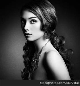 Beauty woman with long curly hair. Beautiful girl with elegant hairstyle. Fashion photo. Black and white